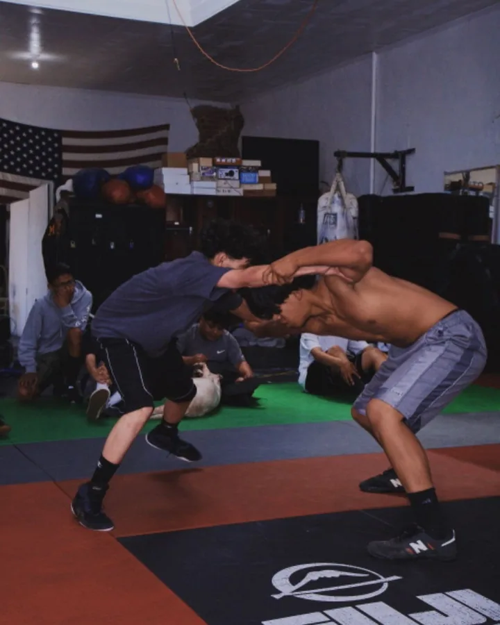 Members drilling wrestling takedowns on the mats at Ventura Fight & Fitness