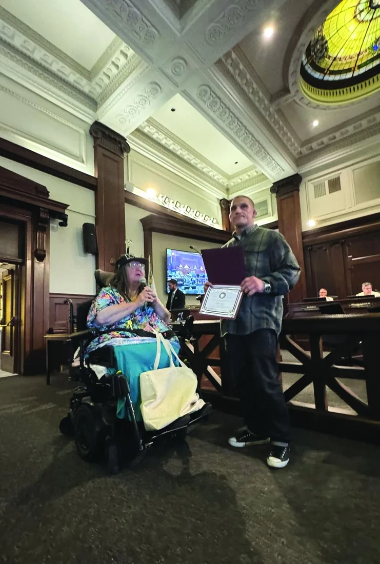 Bobby Taylor holding a City of Ventura certificate at a council meeting